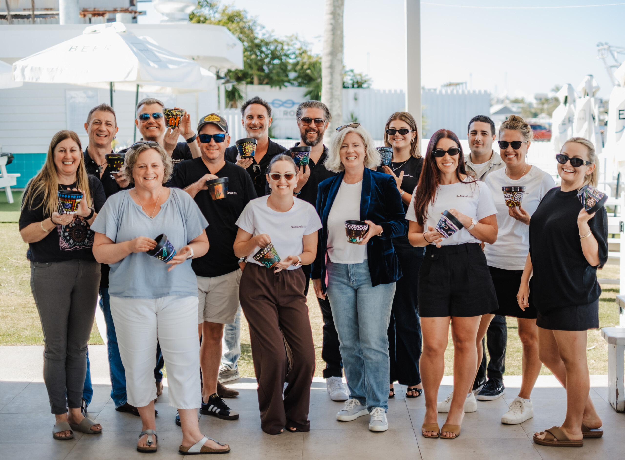 Direct sales team from a transit advertising company standing together at a team event, showcasing collaboration and expertise.